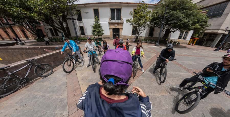 Biking in Full Color: Urban Art Bike Tour - Starting in La Candelaria: the big red wall and the purple-hoodie guide